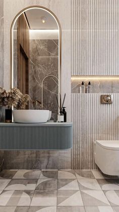 a bathroom with a sink, toilet and mirror on the wall next to a tiled floor