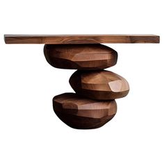 three wooden balls stacked on top of each other in front of a white background,