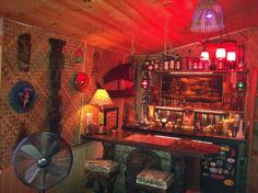 an old fashioned bar with lots of bottles on the shelves and fan in front of it