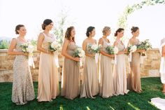 a group of women standing next to each other on top of a lush green field