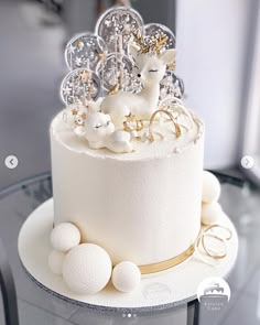 a cake decorated with white frosting and gold decorations