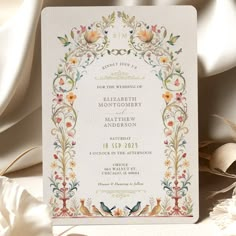 a wedding card with flowers and birds on it