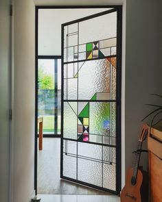 a glass door that has been decorated with geometric designs