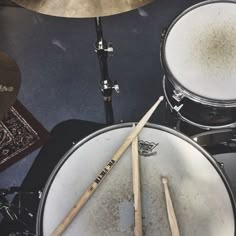 drums and sticks are sitting on the floor