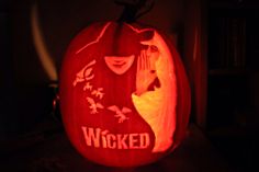 a pumpkin carved to look like a woman's face with the words wicked on it