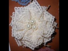 two white lace flowers with pearls on them