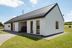 a white house sitting on top of a lush green field