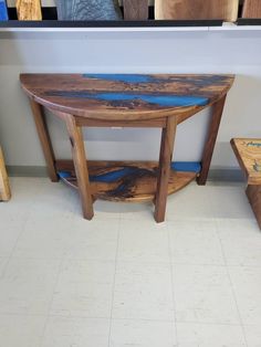 a wooden table sitting on top of a white tiled floor