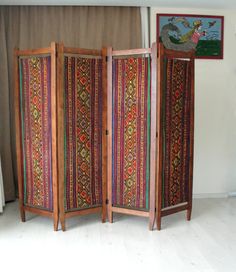 This gorgeous colorful bohemian upholstered wooden room divider would look great anywhere in your living room, office or bedroom. It is entirely made of solid cherry wood and is made in the 1920s or 1930s. PLEASE CONTACT US WITH YOUR LOCATION FOR AN EXACT SHIPPING QUOTE! It has been entirely sanded, stained and oiled. The original fabric was beyond redemption so we replaced it with vintage kilim. Making it a bold, rich, and statement piece of furniture. It would look great in the middle of a roo Room Divider Inspiration, 1920s Room, Privacy Screen Indoor, Wooden Divider, Privacy Screens Indoor, Room Divider Shelves, Hippie House, Screen Divider, Geometric Furniture