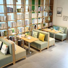 a room filled with furniture and bookshelves full of books on the shelves next to each other