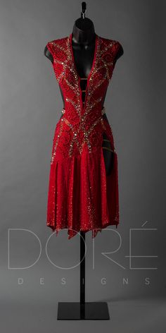 a red dress with gold sequins on the shoulders and neckline, displayed on a mannequin