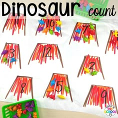 the dinosaur count counting game is made with colored paper and plastic straws to teach numbers