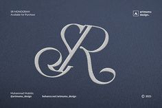 the letter k is made up of white thread on a dark blue background, and it appears to be monogrammed