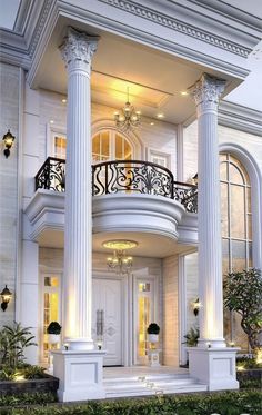 a large white house with columns and lights