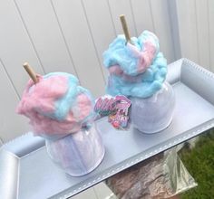 two ice cream sundaes sitting on top of a table