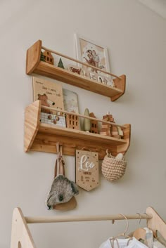 two wooden shelves on the wall above a crib