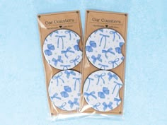 two blue and white coasters with bows on them