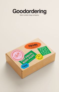 a cardboard box with some stickers on the inside and outside, in front of a white background