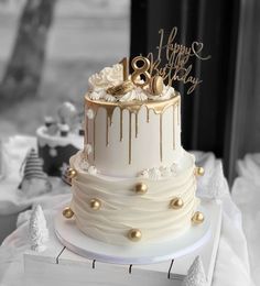 a white cake with gold decorations on top