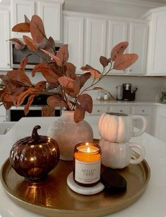 a candle is sitting on a tray in the kitchen