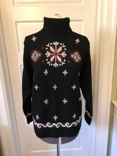 The perfect sweater for that winter ski trip! This sweater is made of 94% wool, 3% acrylic, and 3% mohair in black knit. I believe the mohair is in the white and red cross stitched snowflake designs on the sweater.  It features a ribbed turtleneck, long sleeves with ribbed cuffs and a wave design near the cuffs, and a ribbed waistband. The snowflakes are throughout, with larger designs on the upper front. This garment is clean, with no stains, snags, or moth holes. I did repair three holes and I think you will be hard pressed to find them! Measurements to guide you: Armpit to armpit: 19.5" Waist across: 19.5" Sleeve: 22.5" Length from top of shoulder to hem: 25" Please compare your own measurements with those provided above for assurance of fit.  The tag designates this as a petite. Decade Red Cross Stitch, Perfect Sweater, Ski Sweater, Snowflake Design, Wool Turtleneck, Ribbed Turtleneck, White Snowflake, Snowflake Designs, Pullover Sweater Women