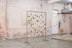 an art installation is displayed in the middle of a room with concrete floors and walls