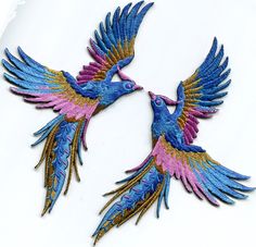 two pink and blue birds flying next to each other