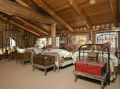 an attic bedroom with wooden beams and exposed ceiling, two twin size beds in the foreground