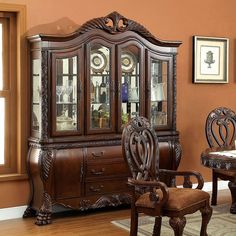 an ornate china cabinet with glass doors and carved wood trimmings in a dining room