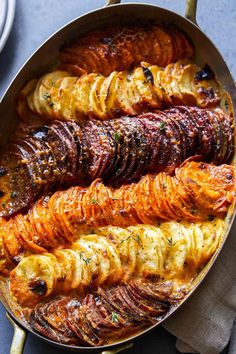 a pan filled with different types of food on top of a blue and white table cloth