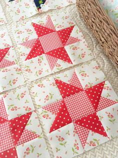 some red and white quilts sitting on top of a table