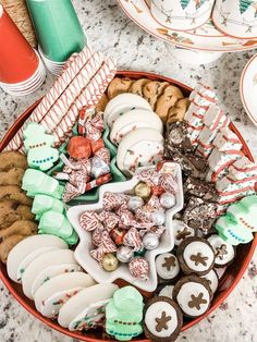 a bowl filled with lots of different types of cookies and candies on top of a table