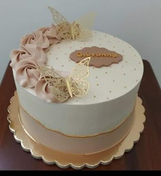 there is a white cake with gold decorations on it