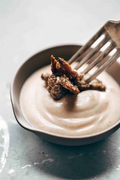 a fork in a bowl with some food on it