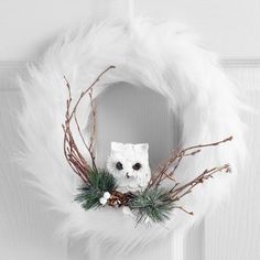 a white wreath with an owl on it