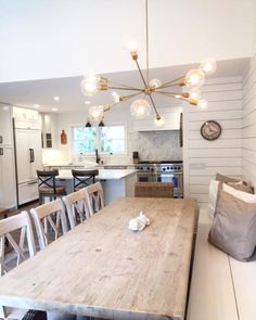 a wooden table sitting in the middle of a kitchen