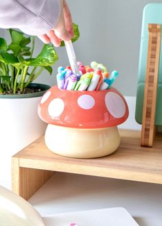 Chill mushroom vibes. This sturdy mushroom pot makes the perfect home for houseplants — we’ve even included a drainage hole for easy watering. It can hold small plants, succulents, pens, and bunches (and bunches and bunches) of happiness. We could all use a cheery little mushroom friend! Each mushroom planter is cerami Mushroom Vibes, Mushroom Planter, Little Mushroom, Plants Succulents, Tanah Liat, Clay Diy Projects, Cute Bedroom Decor, Cute Room Ideas, Cute Clay