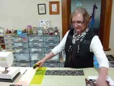 an older woman is working at a sewing machine