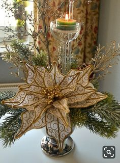 a christmas centerpiece with candles and decorations