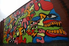 a large colorful mural on the side of a building