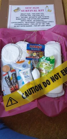 the contents of a diaper box are wrapped in pink paper and taped to a yellow ribbon