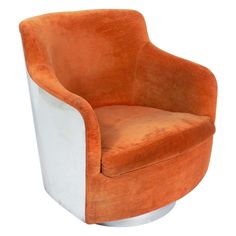 an orange and white chair sitting on top of a metal base