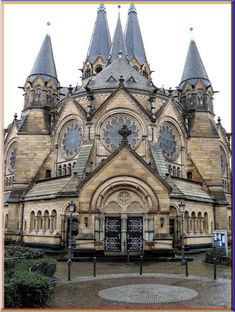 an old building with many spires on it's roof and two clock faces