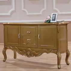 an ornately decorated sideboard with drawers in a living room or dining room area