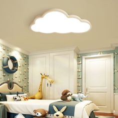 a child's bedroom decorated in blue and white with stuffed animals on the bed