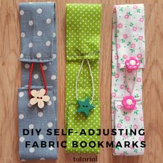 three folded fabric bookmarks with flowers and stars on them