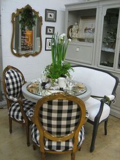 the dining room table is decorated with black and white checkered upholstered chairs