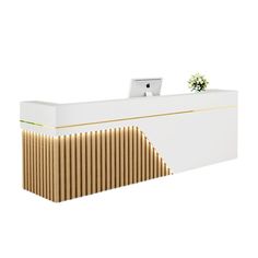 a white reception desk with wooden slats on the front and side panels, along with a plant