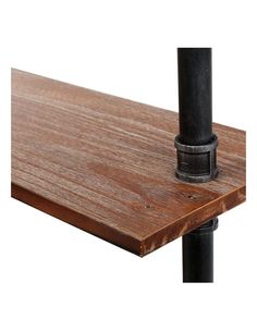 a close up of a wooden table with black metal legs and an iron pipe sticking out of it