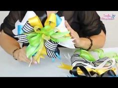 a woman is holding some colorful ribbons on her hand and the ribbon has been tied to it